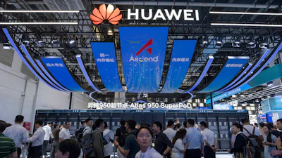 Visitors past by the Huawei booth display of the Atlas 950 SuperPoD during the World AI Conference in Shanghai, China on Friday, July 17, 2026.