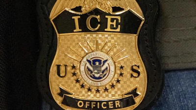 A federal agent wears an Immigration and Customs Enforcement badge in New York, June 10, 2025.