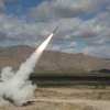 A Northrop Grumman-built solid rocket motor powering a Guided Multiple Launch Rocket System (GMLRS) missile for the U.S. Army.