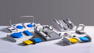 Collection of blue and yellow control panel prototypes and interface devices arranged on white surface