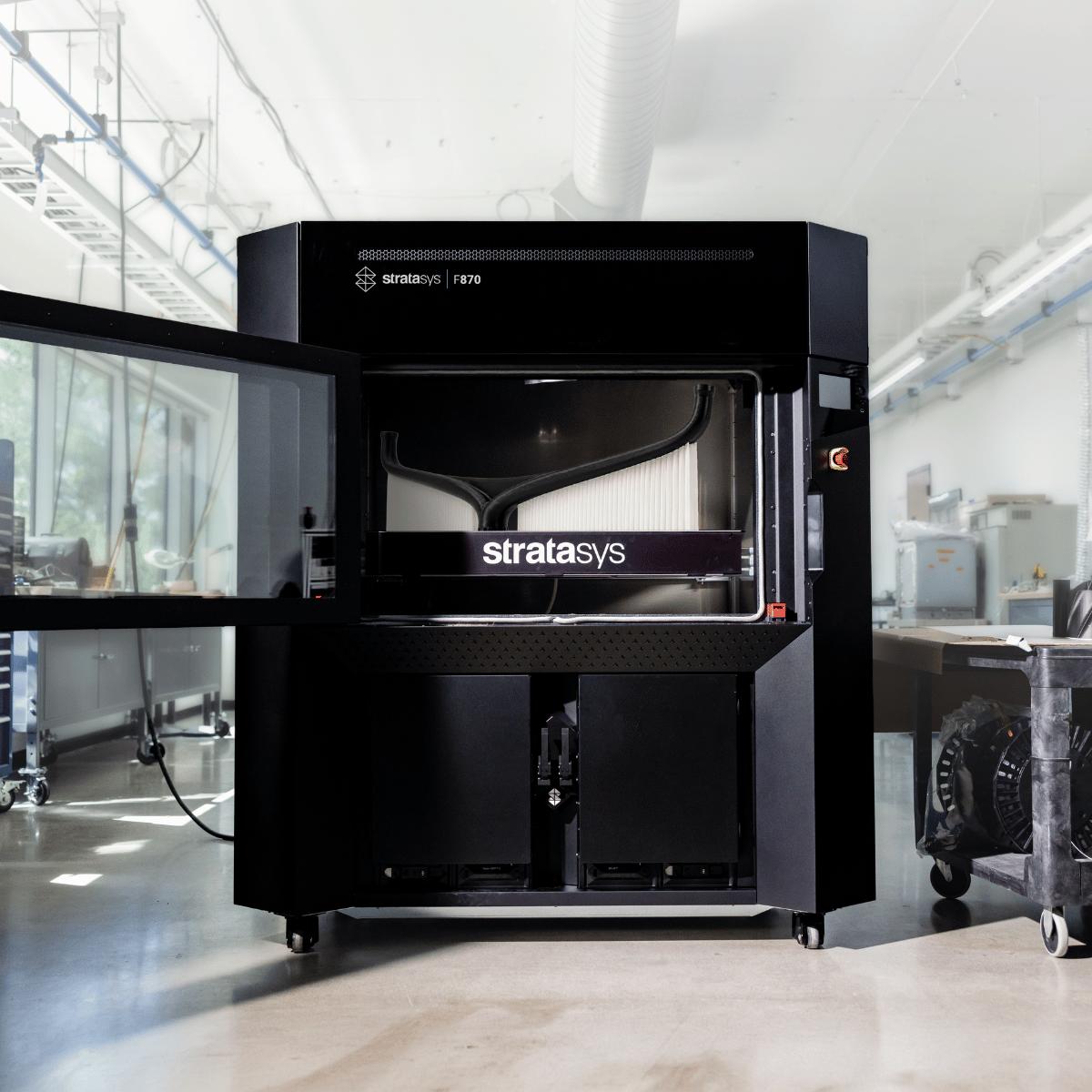 Stratasys F170 3D printer in industrial laboratory setting with white walls and equipment