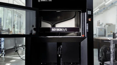 Stratasys F170 3D printer in industrial laboratory setting with white walls and equipment