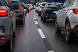 Heavy traffic congestion on a multi-lane highway with vehicles stopped bumper-to-bumper during rush hour.