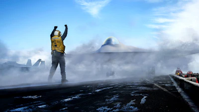Person in yellow vest stands triumphantly on volcanic landscape with UFO and spacecraft visible in cloudy sky