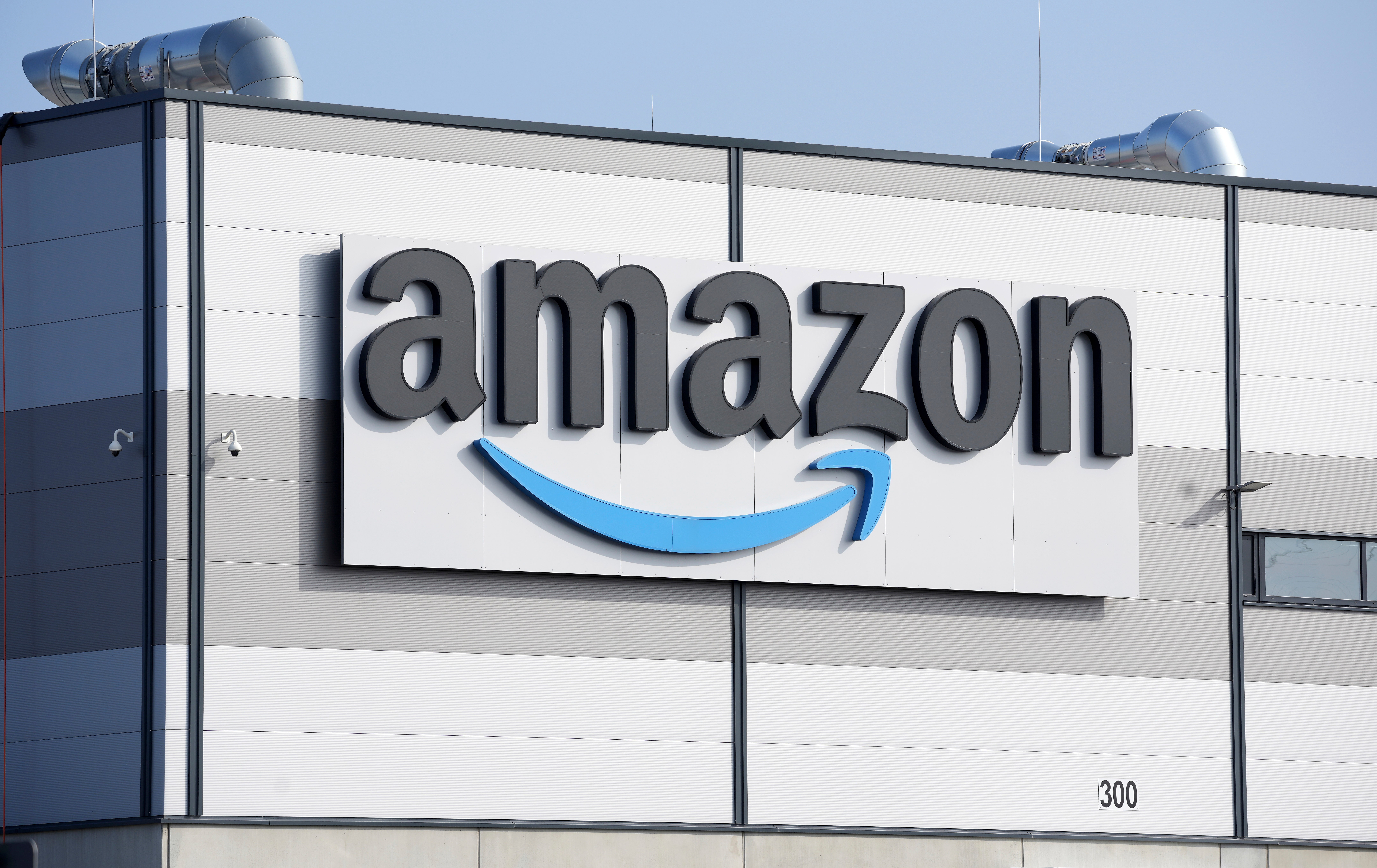 Amazon logo on industrial warehouse building exterior signage