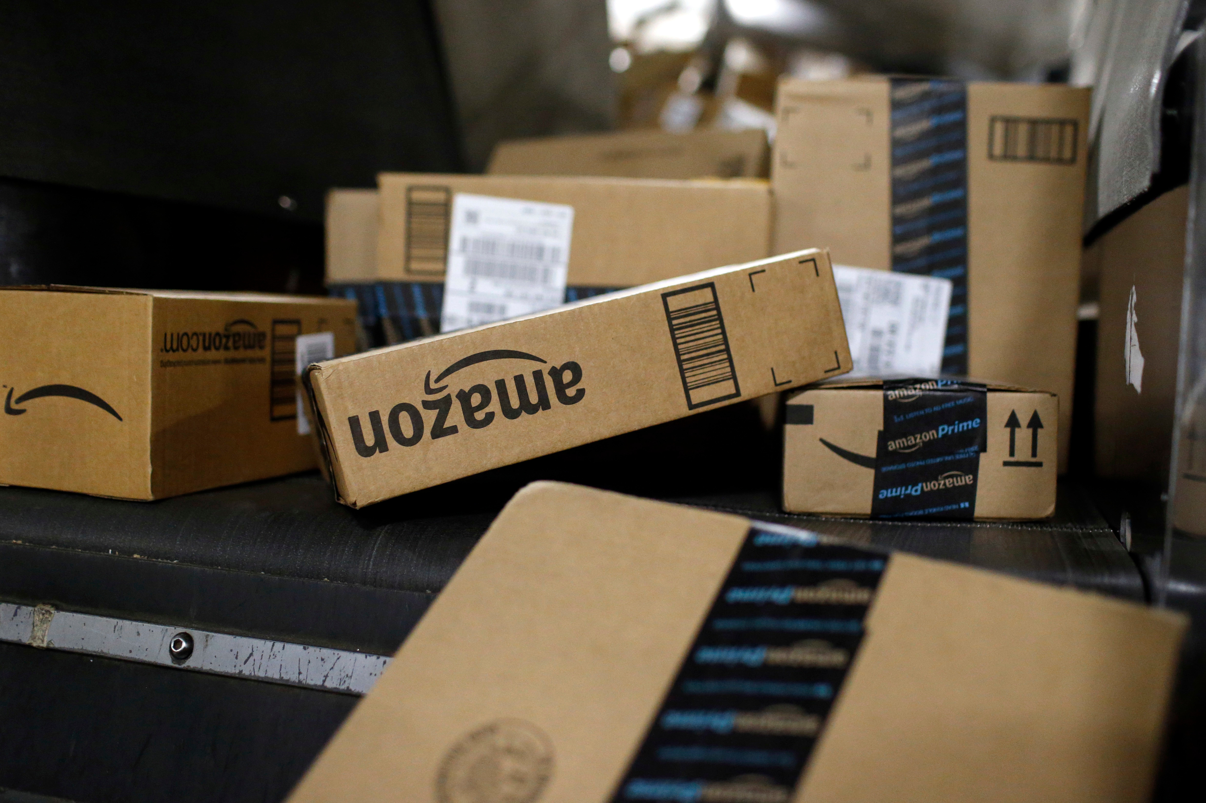 Packages in Amazon boxes move along a conveyor belt at the UPS Worldport hub in Louisville, Ky., Nov. 20, 2015.