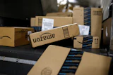 Packages in Amazon boxes move along a conveyor belt at the UPS Worldport hub in Louisville, Ky., Nov. 20, 2015.