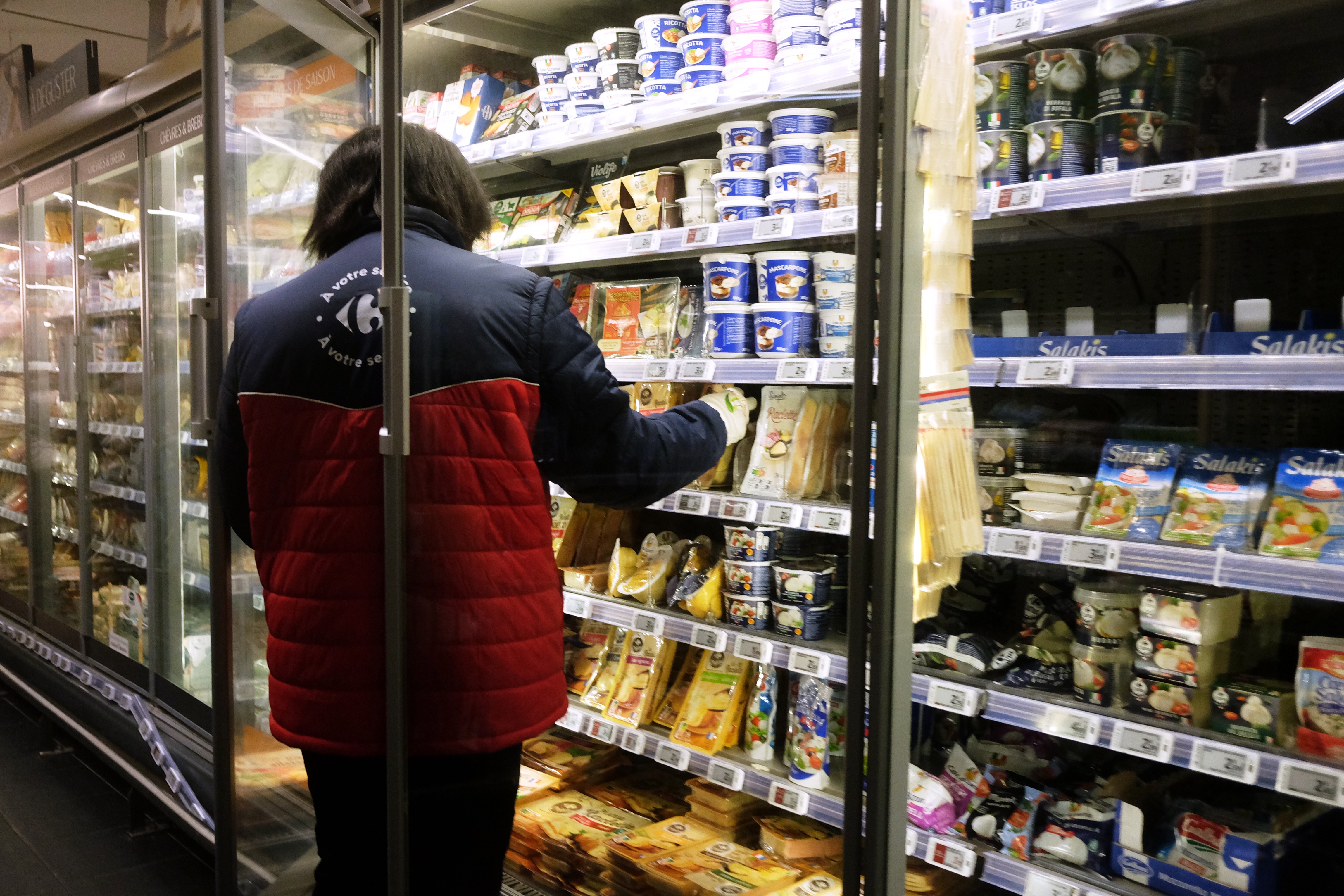 A worker restocking products in a supermarket in Montreuil, France, Oct. 14, 2026.