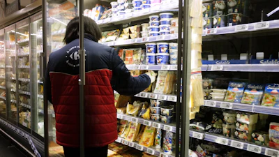 A worker restocking products in a supermarket in Montreuil, France, Oct. 14, 2026.