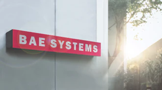 BAE Systems red and white exterior building sign mounted on modern facade with natural sunlight
