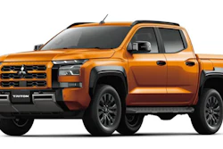 Orange Mitsubishi Triton pickup truck shown in profile view against white background