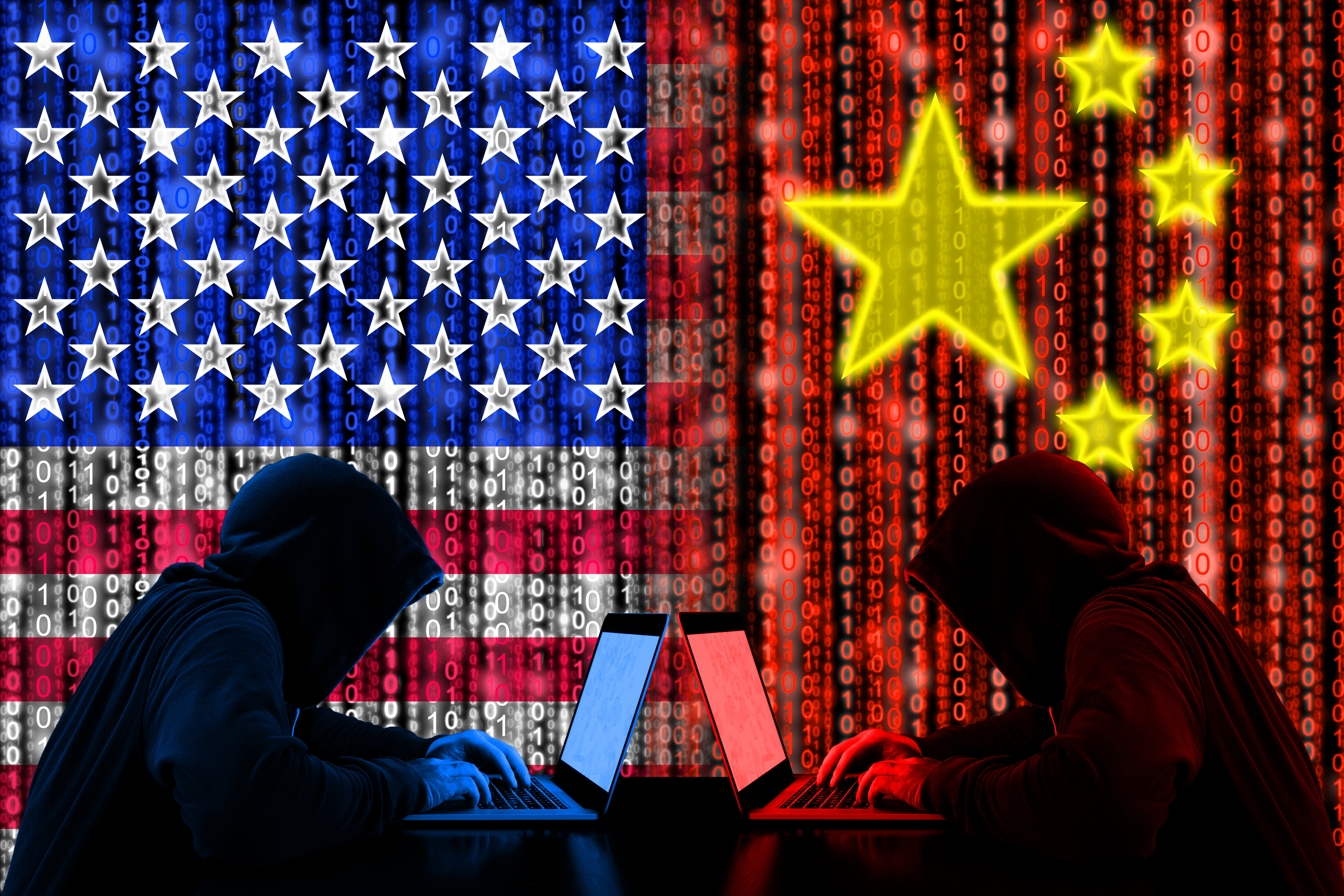 Silhouetted hackers at laptops facing each other against US and Chinese flag backgrounds with binary code and stars, representing cyber conflict.