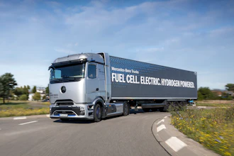 Mercedes-Benz fuel cell electric hydrogen-powered truck driving on highway with green landscape