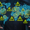 Global cybersecurity threat visualization with warning symbols and digital network indicators on world map