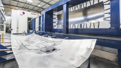 Industrial CNC sheet metal processing machine with blue frame in modern manufacturing facility
