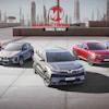 Five VinFast electric vehicles displayed on a rooftop with city skyline backdrop and Manufacturing Now branding