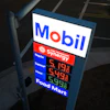 Mobil gas station price sign displaying fuel prices with Synergy branding and Food Mart services