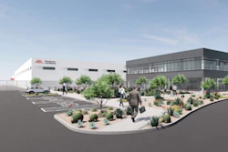 Architectural rendering of modern office and industrial facility with white and gray buildings, desert landscaping, parking area, and people in courtyard.