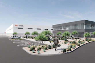 Architectural rendering of modern office and industrial facility with white and gray buildings, desert landscaping, parking area, and people in courtyard.