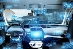 Futuristic car interior with digital dashboard displays and blue holographic interface elements representing autonomous vehicle technology
