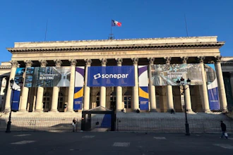 Classical building facade with Sonepar blue banner signage and columns under clear blue sky