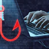 Red phishing hook icon with code and hands typing on laptop representing cybersecurity threat
