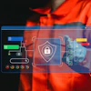 Person in orange jacket interacting with holographic cybersecurity interface displaying shield and padlock security icon