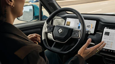 Driver with hands on steering wheel inside modern autonomous vehicle with digital dashboard display