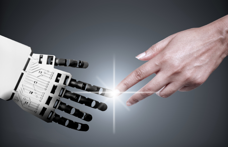 Human hand reaching toward robotic hand in a gesture of connection and collaboration against a gray background with light rays