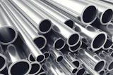 Stacked polished metal tubes and pipes arranged diagonally showing circular openings and reflective surfaces
