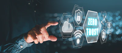 Hand reaching toward glowing hexagonal security icons with Zero Trust text in teal and blue digital interface